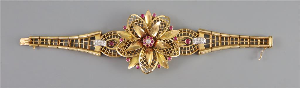 An ornate pierced 14ct gold, ruby and diamond set tapering bracelet,